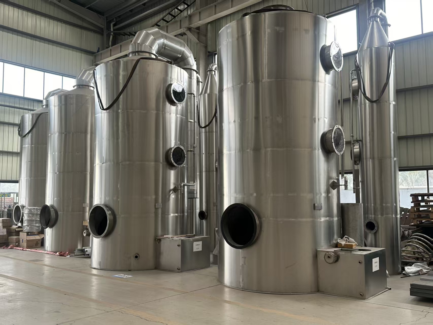 Stainless steel industrial air treatment vessels in a workshop
